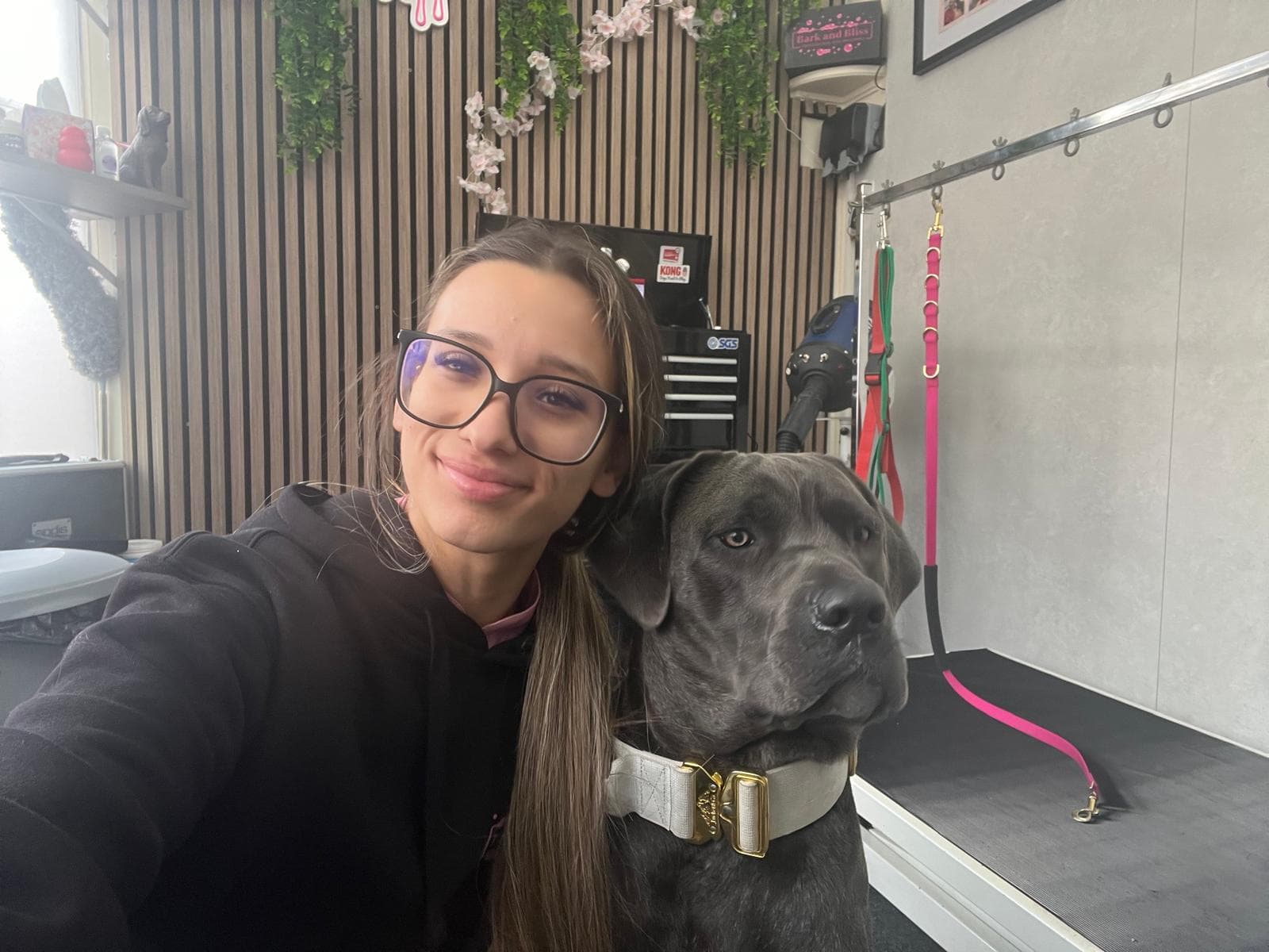 Kelly with a happy dog in the Bark & Bliss salon in Rugby